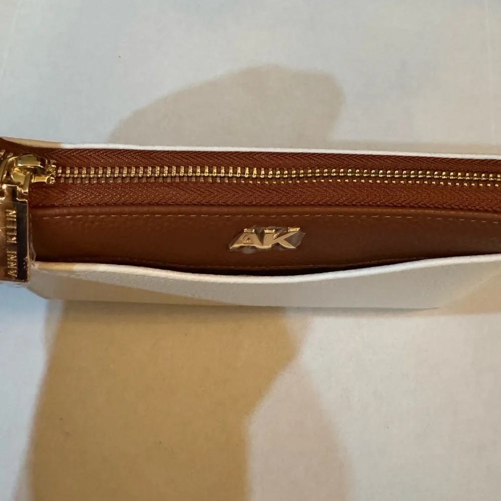 Anne Klein AK Logo Slim Zip Around Wallet in a two-tone Cream and Brown/Saddle